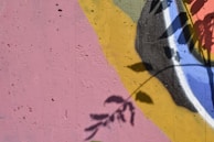 Creative decorative painting on a feature wall with vibrant colors and organic shapes.