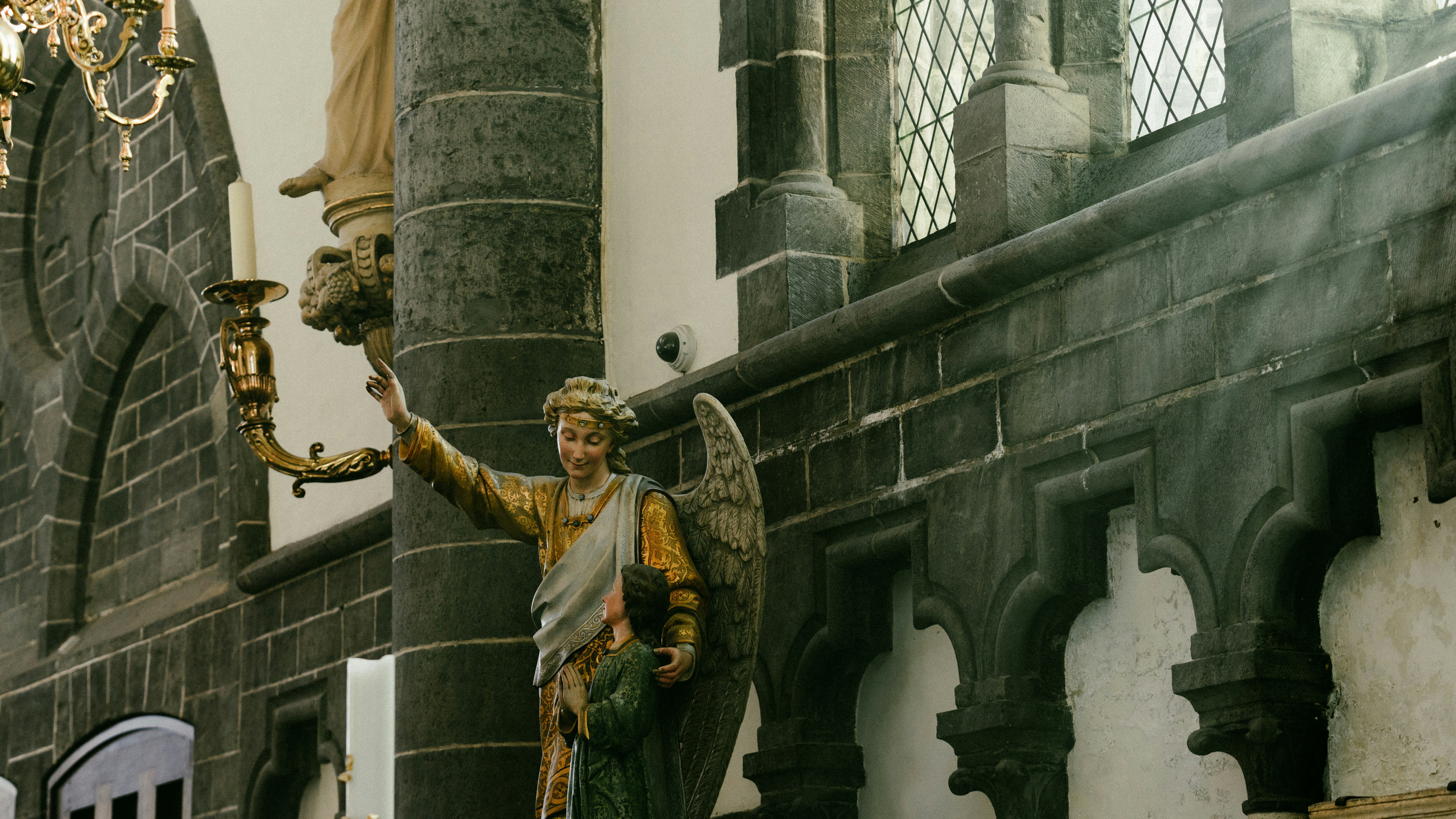 a statue of a man holding a candle in his hand