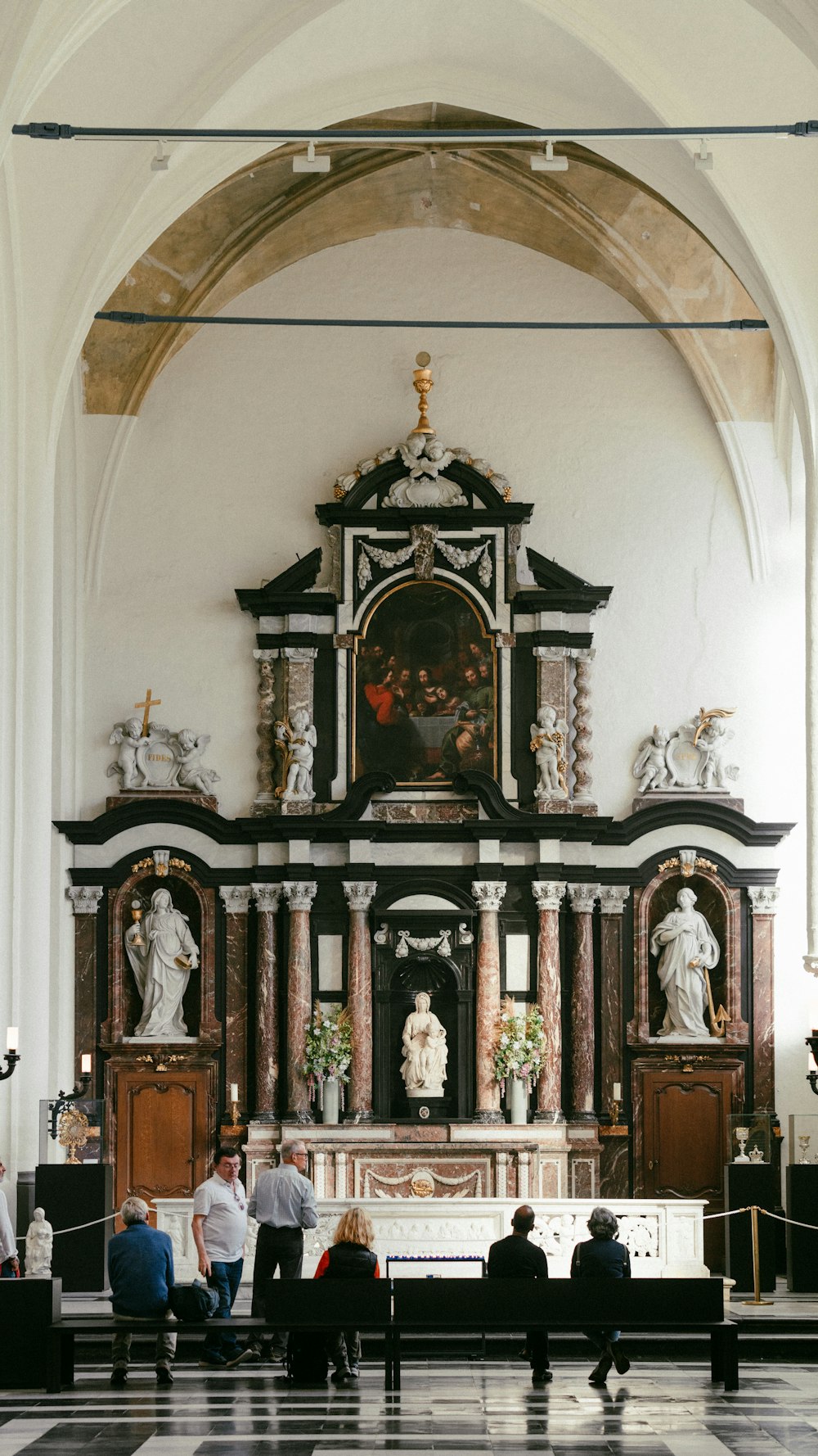 a group of people sitting in front of a church alter