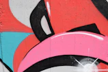 A vibrant urban mural featuring bold black and white contrasts with splashes of red.