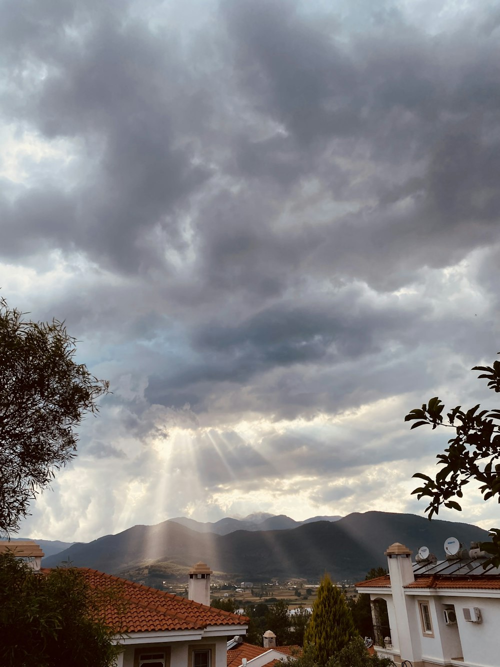 the sun shines through the clouds over a residential area