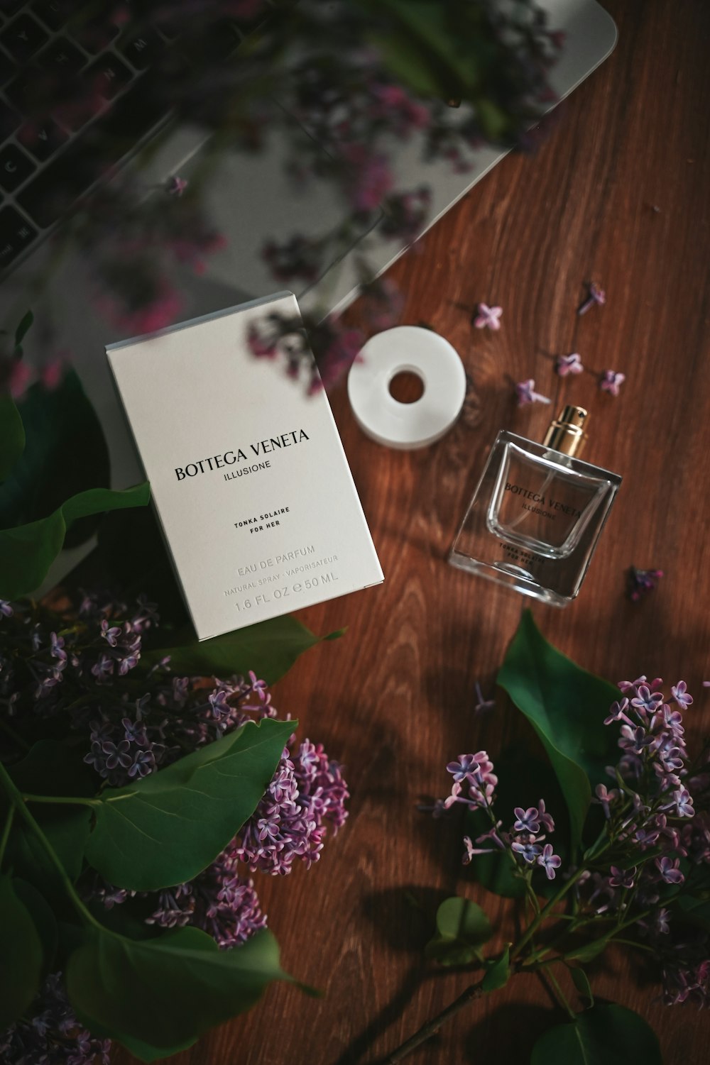 a bottle of perfume sitting on top of a wooden table