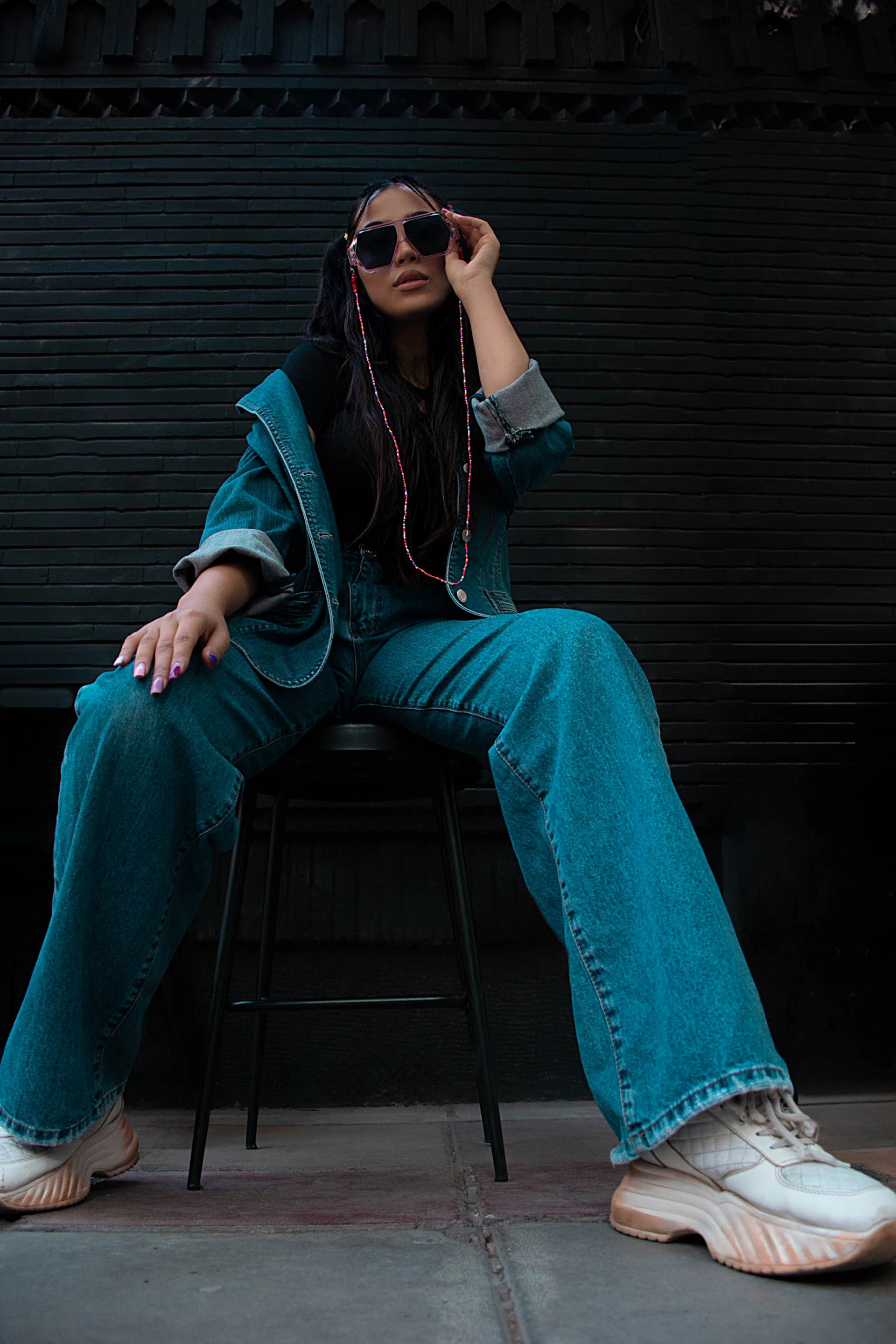 a woman sitting on top of a chair wearing headphones