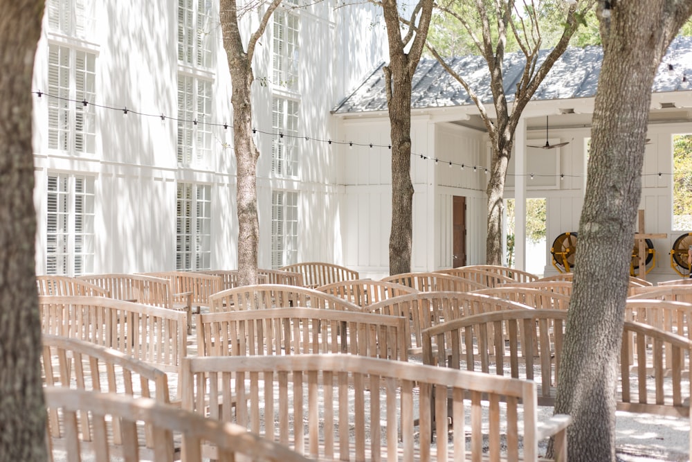 a row of wooden benches in front of a building