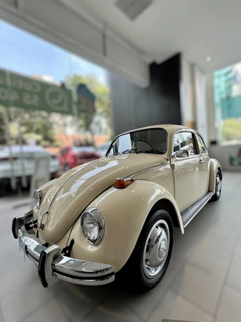A classic vintage car displayed in a cozy showroom.