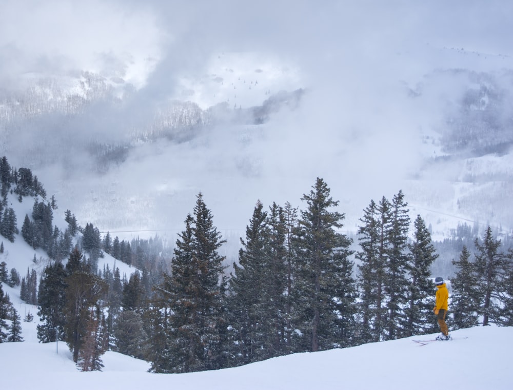 a person standing on a snow covered slope