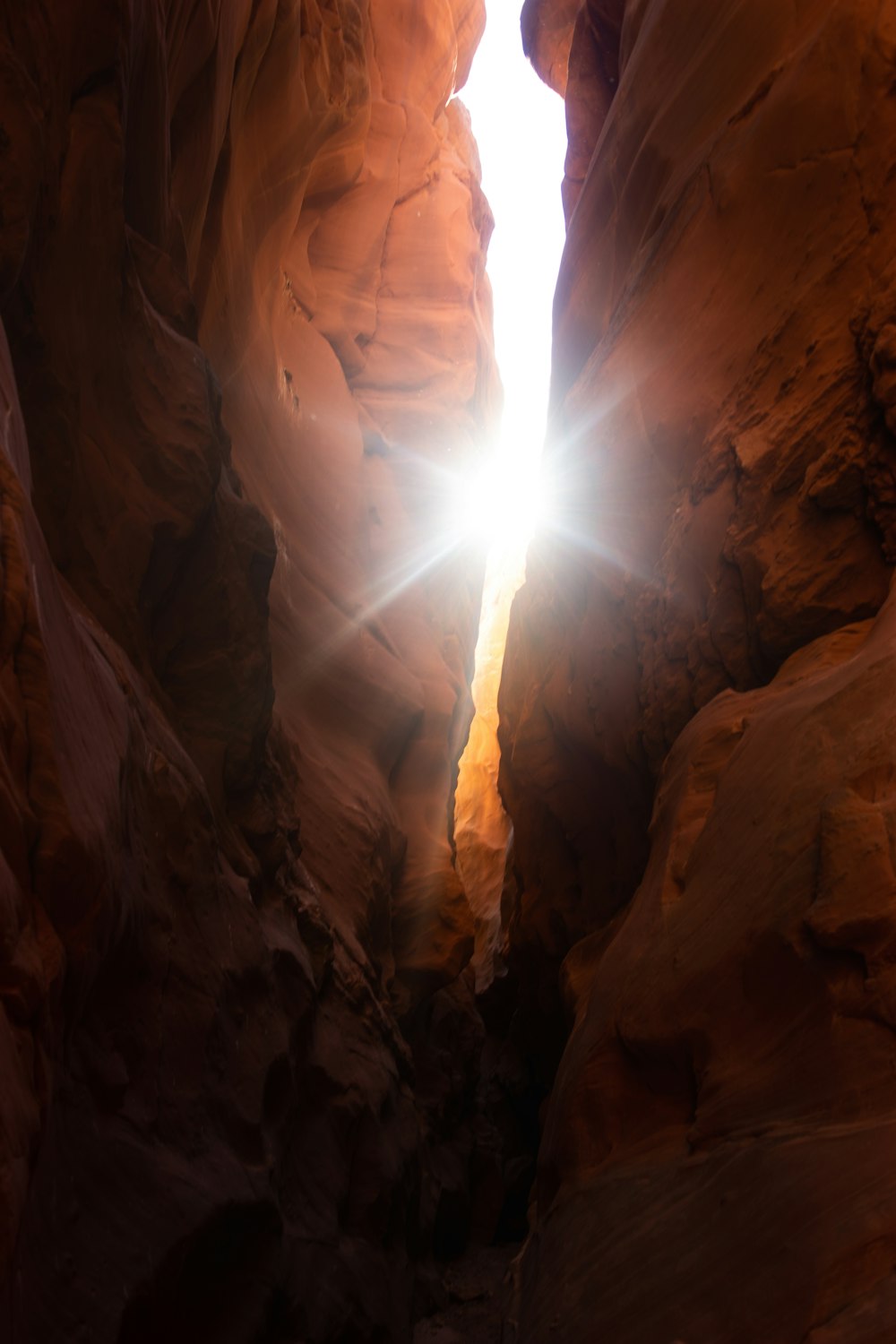 a light shines through a narrow slot in a rock formation