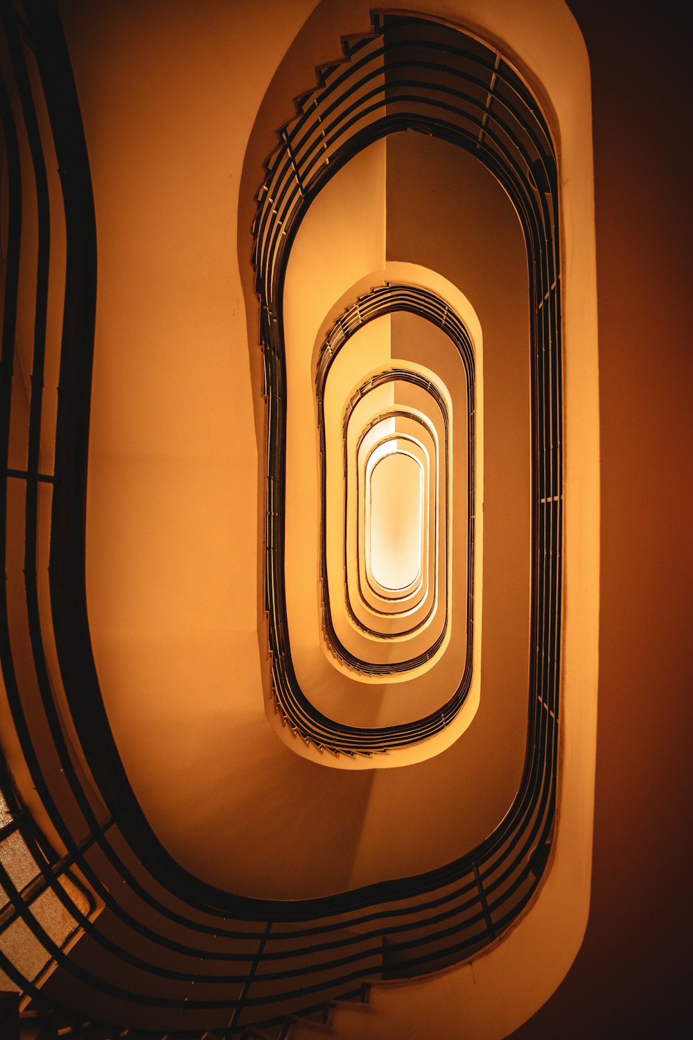 a spiral staircase with a light at the end