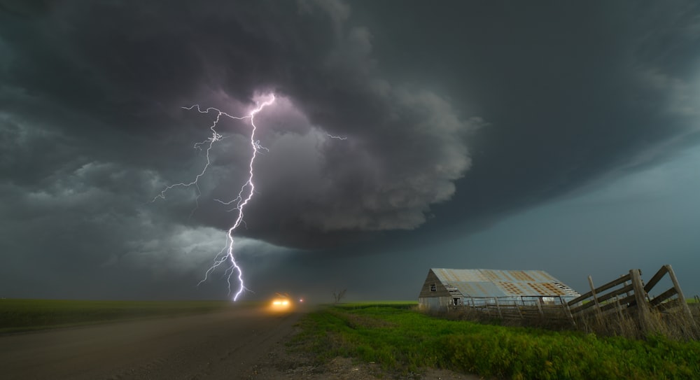 a lightning bolt hitting over a farm in the country