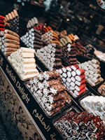 An elegant platter of colorful Turkish delights dusted with powdered sugar, set against a rich velvet fabric.