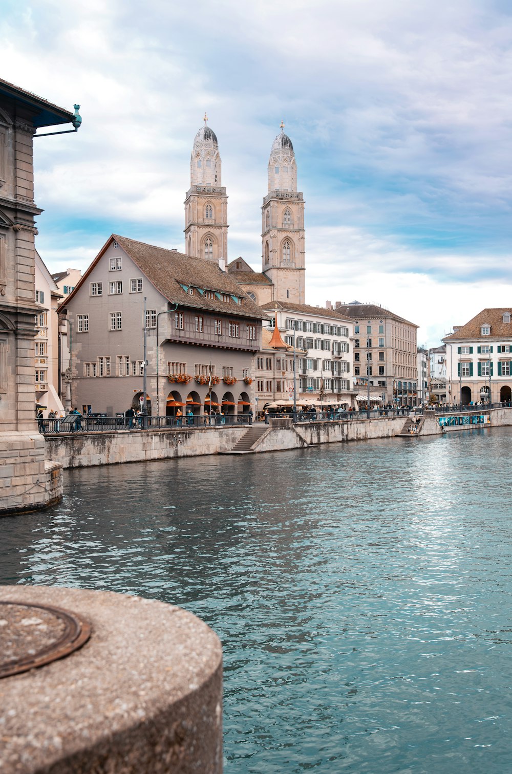 a river running through a city next to tall buildings