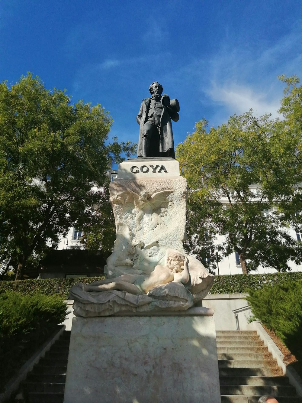 a statue of a man sitting on top of a bench