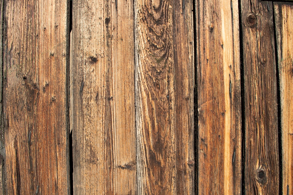 a close up of a wooden fence with a clock on it