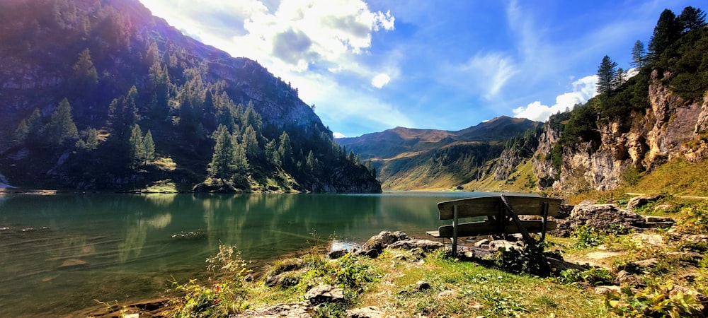 a bench sitting on the shore of a lake