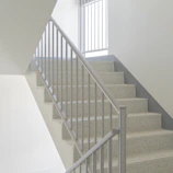 Straight metal staircase with a minimalist design, bright and clean, shown in natural light.