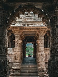 a large stone structure with a couple of people sitting on top of it