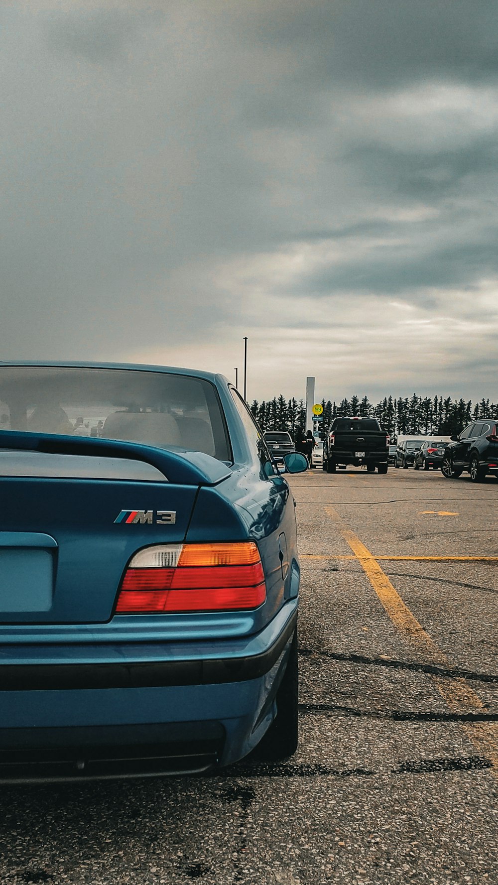 a blue car parked in a parking lot