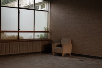 a chair sitting in a room next to a window