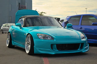 a blue sports car parked in a parking lot