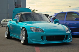 a blue sports car parked in a parking lot