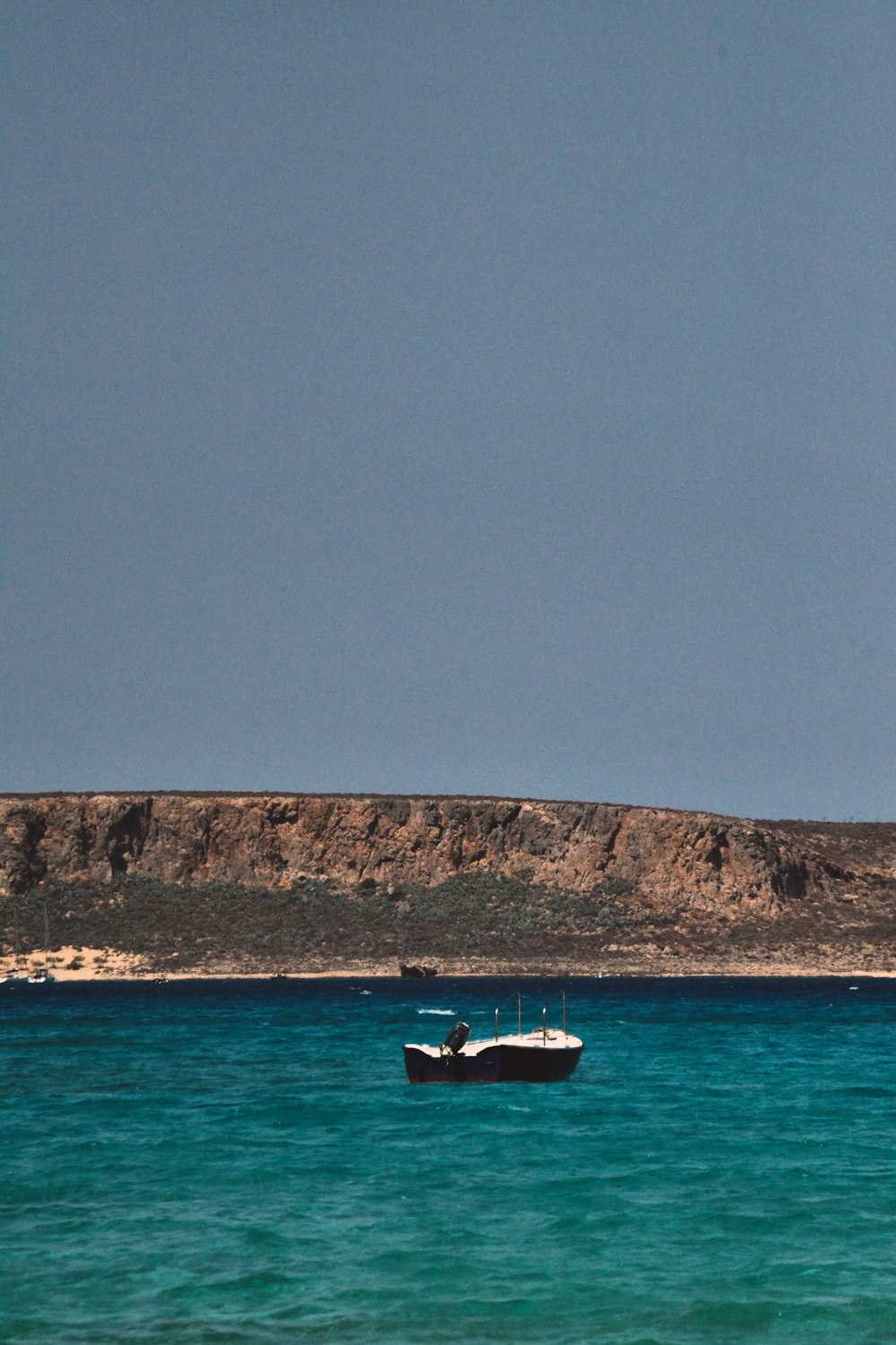 a boat floating in the middle of a body of water