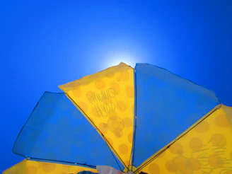 A colorful patio umbrella providing shade on a sunny day.