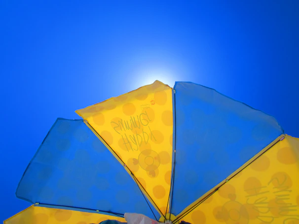 A colorful patio umbrella providing shade on a sunny day.