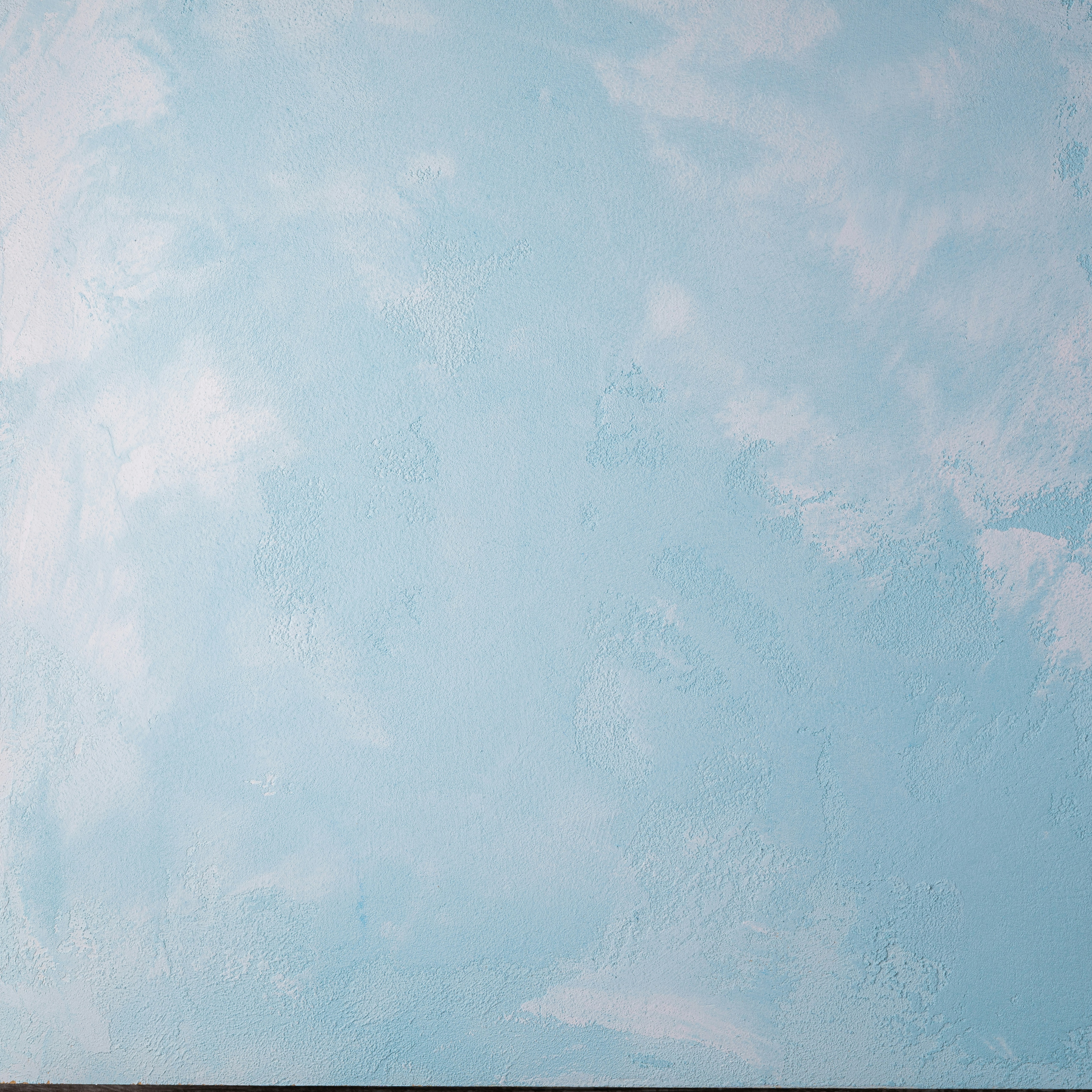 a man riding a skateboard on top of a wooden floor