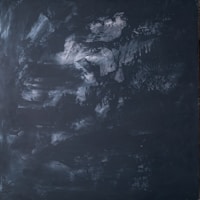 a black and white photo of a black wall