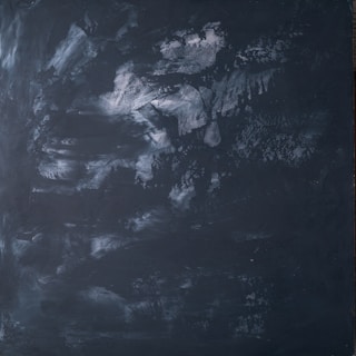 a black and white photo of a black wall