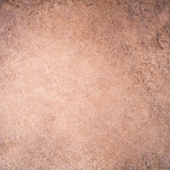 a close up of a brown surface with a black border