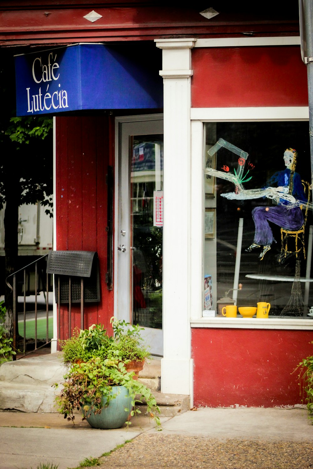 a red building with a blue sign that says cafe inicia