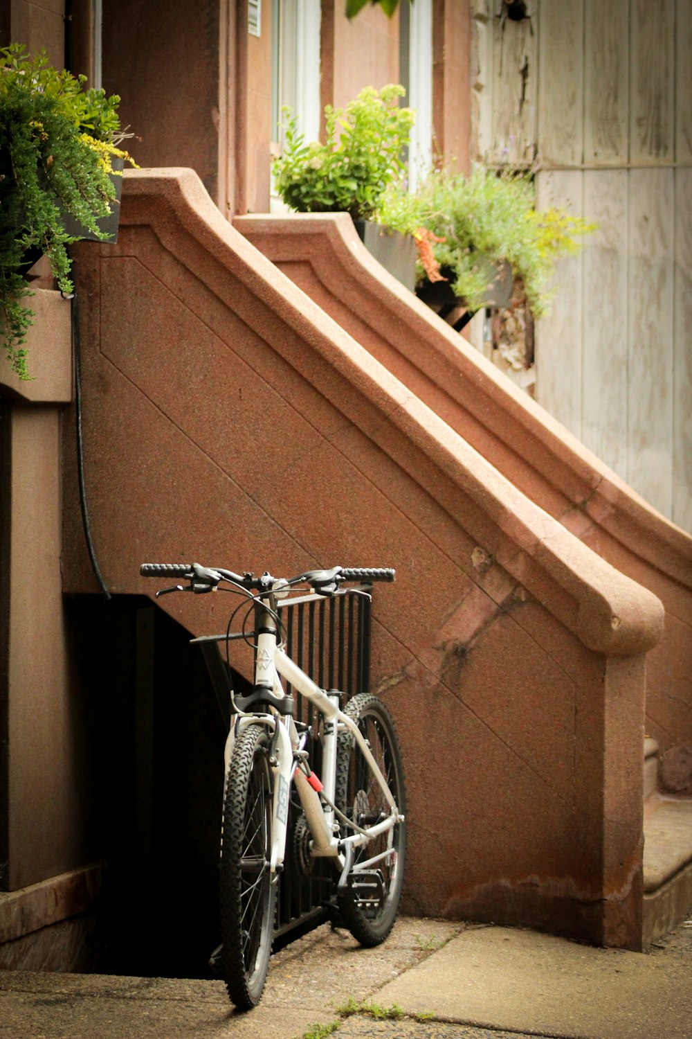 a bicycle parked next to a set of stairs