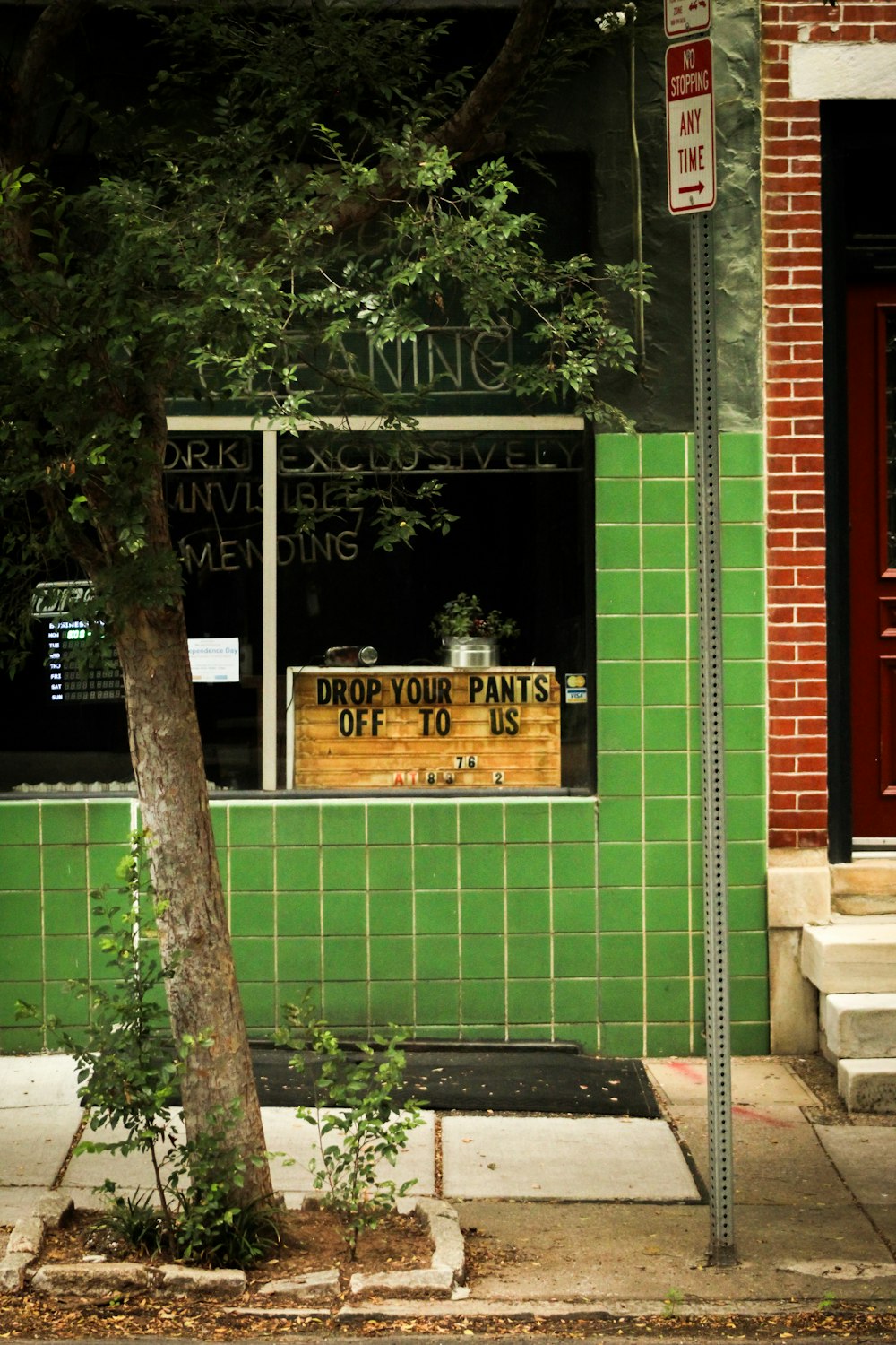 a green building with a sign in front of it