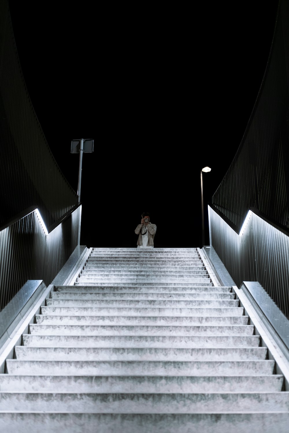 a person walking up a flight of stairs at night