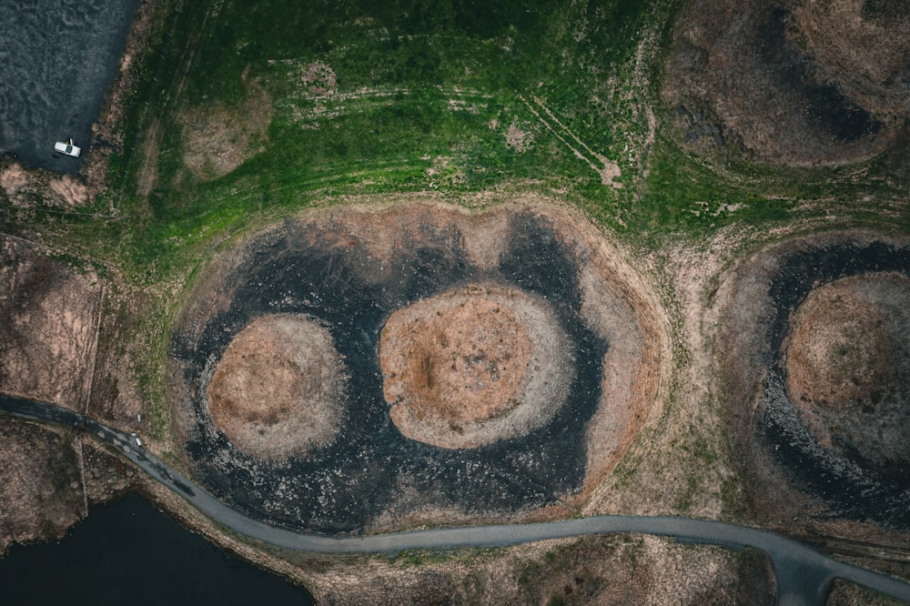 an aerial view of a grassy area with a river running through it