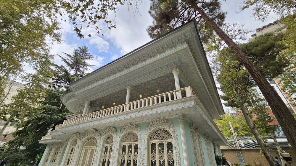 a white building with a balcony and balconies