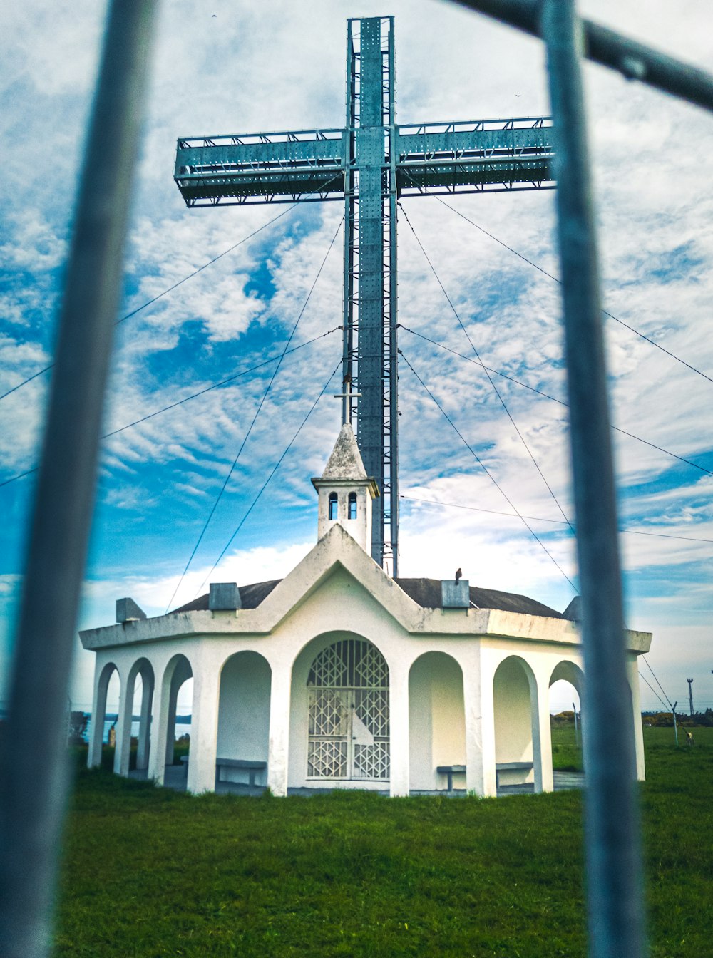 a large white building with a cross on top of it