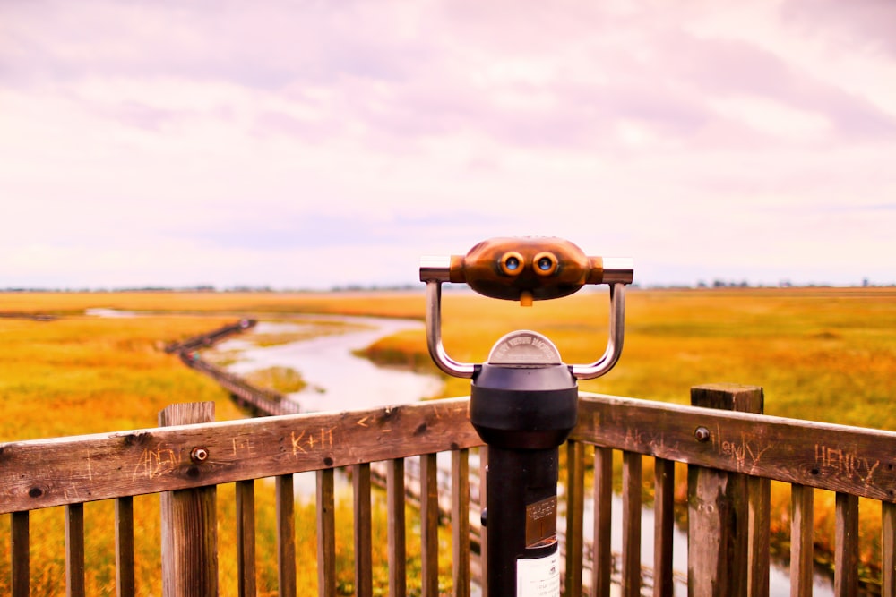 a view of a field from a wooden fence