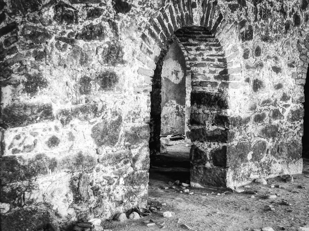 a black and white photo of an old brick wall