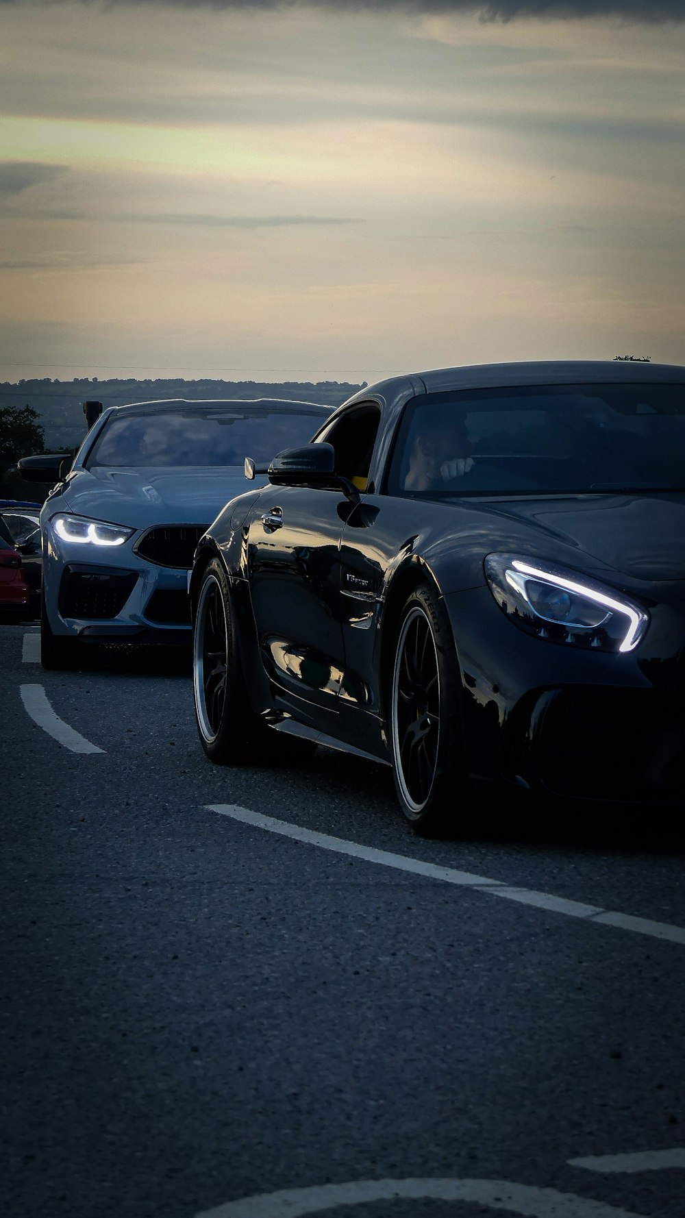 a couple of cars that are sitting in the street