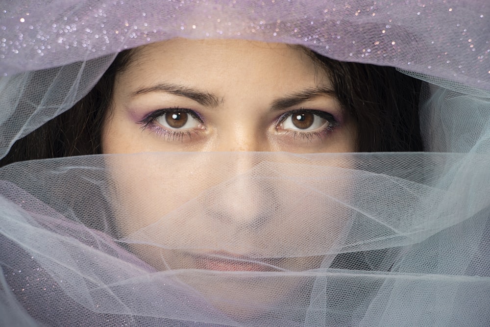 a close up of a person wearing a veil