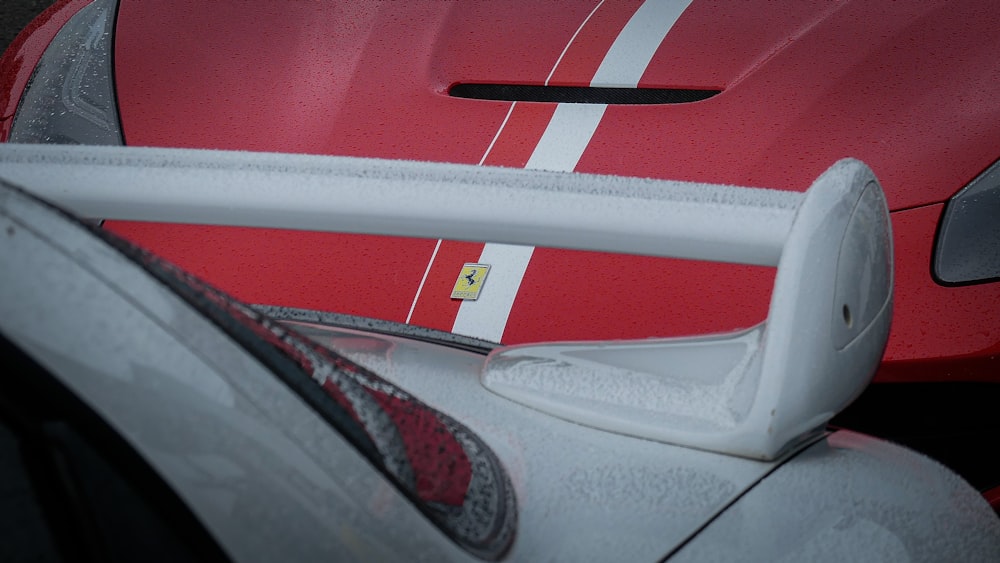 a close up of a red and white sports car