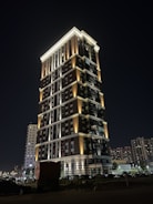 Night view of a luxury commercial property illuminated with warm lighting.