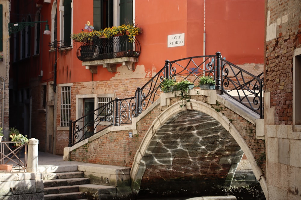 a bridge over a small canal in a city