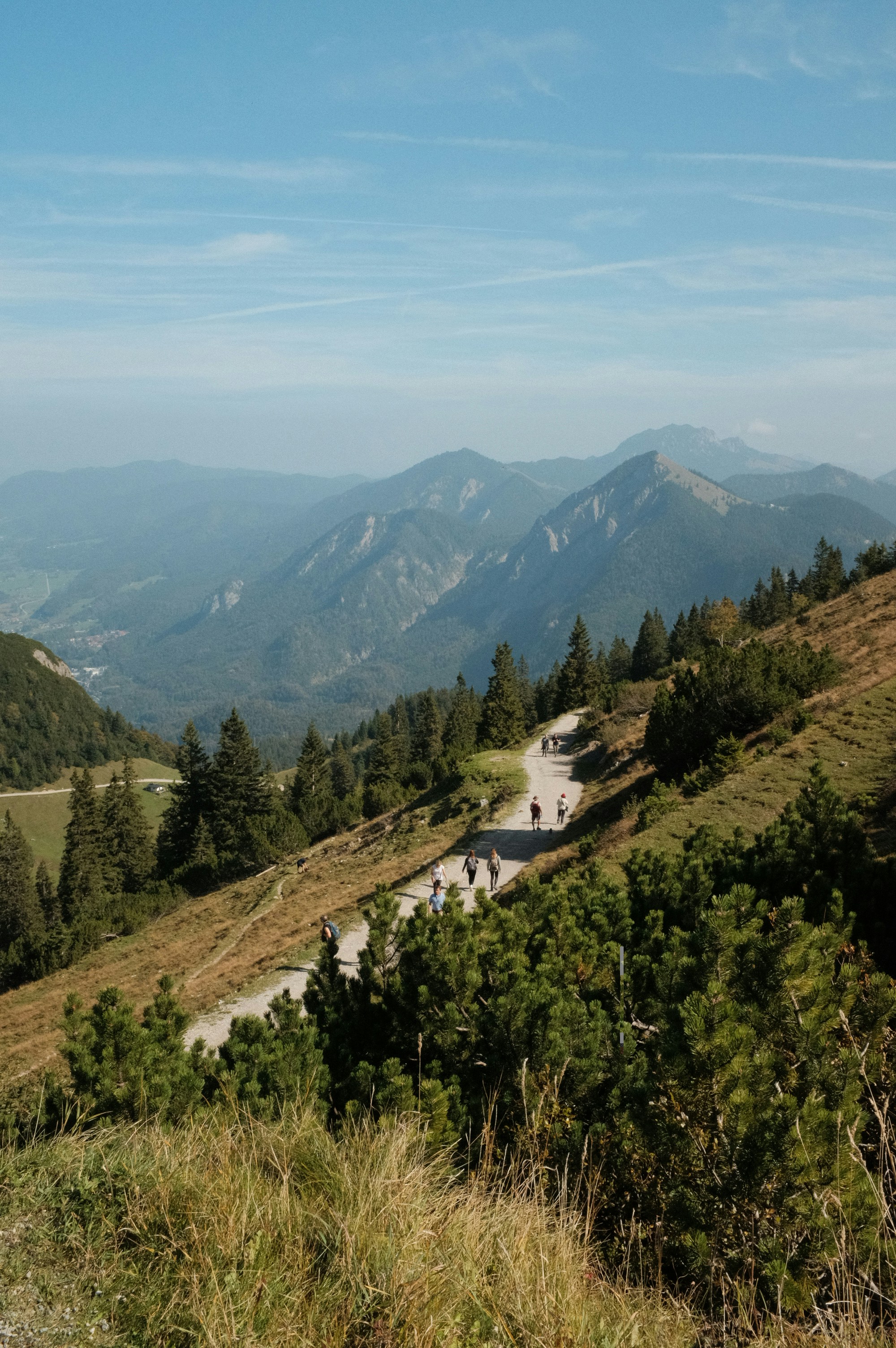 a scenic view of a mountain road with people on it