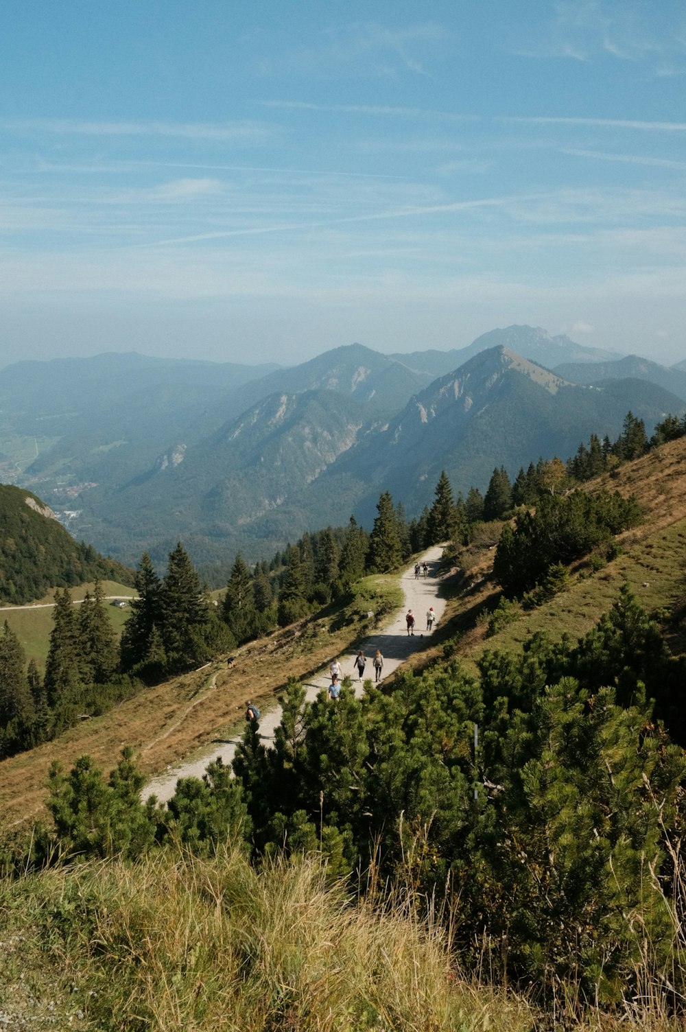 a scenic view of a mountain road with people on it