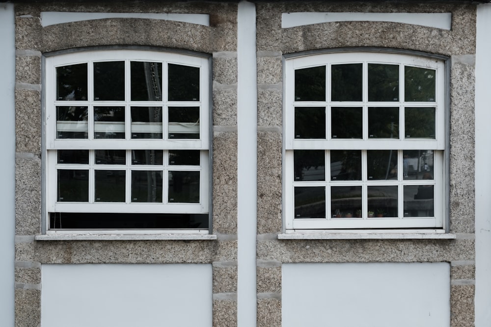a couple of windows that are on the side of a building
