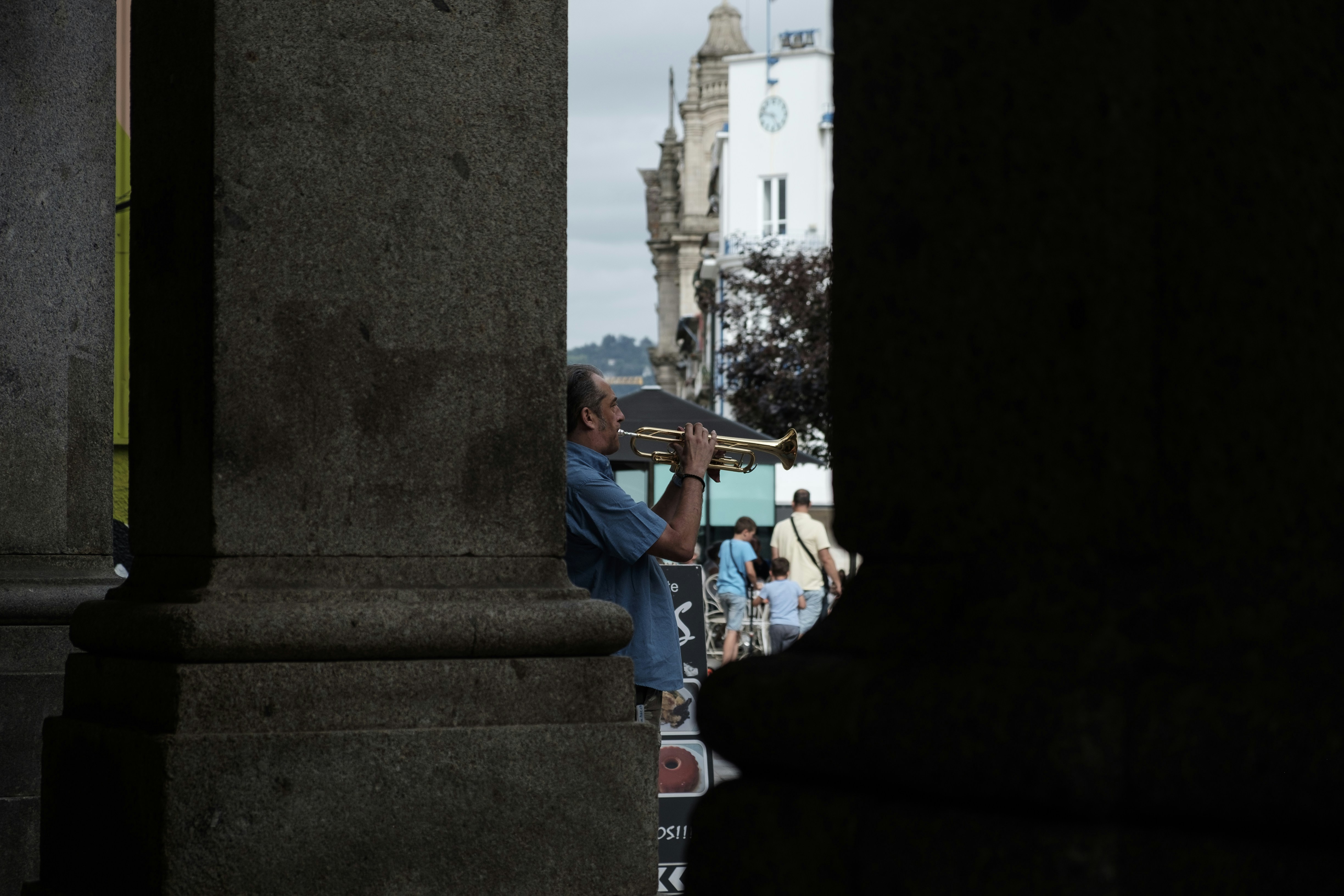 a man holding an umbrella standing next to a tall building