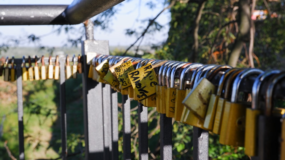 a row of locks attached to a metal fence